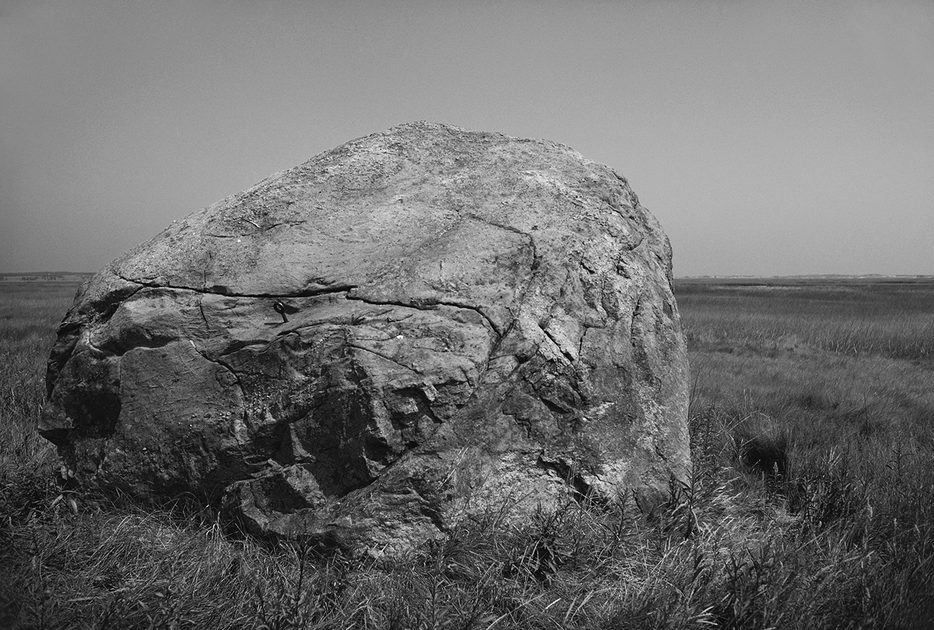 a large boulder in a field